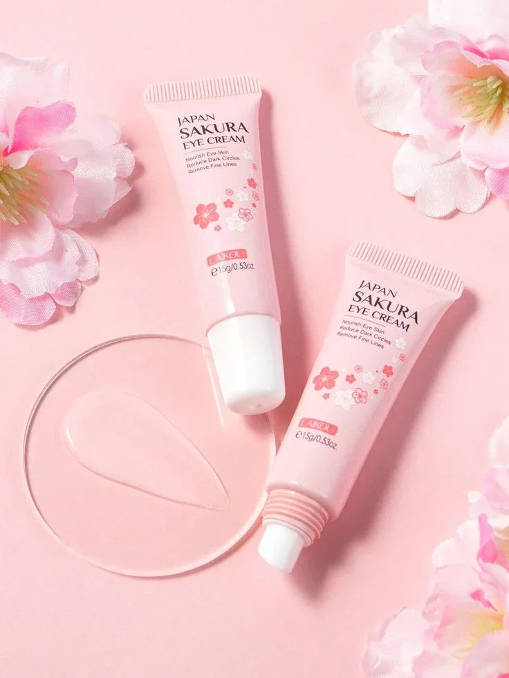 Crema hidratante para ojos Sakura, presentación en tubo rosa, fondo con flores y textura.