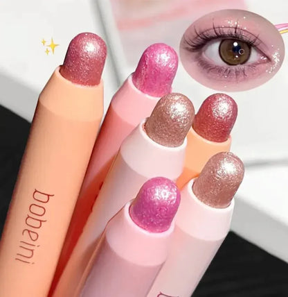 Sombras de ojos en barra coreanas en tonos rosados y dorados con acabado brillante.